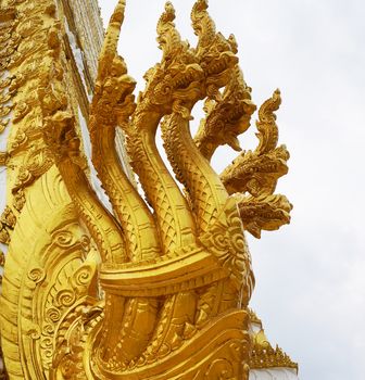  7 heads of great naga statue, has golden yellow built in temple of Laos                              