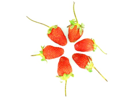 Ripe red strawberry, stalks still attached but began to wilt, arranged in a circle.                              