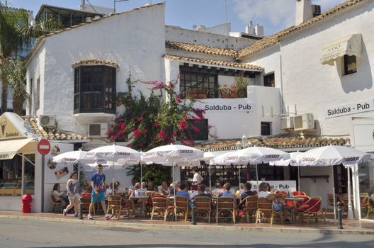 People sitting in a bar of Puerto Banus, a marina located in Marbella, Spain