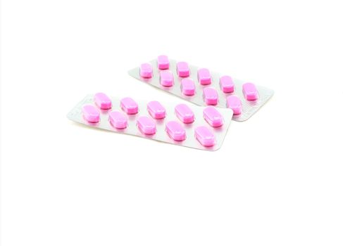 Pink pills in the panel has not been removed. There are two panels placed on a white background.                              