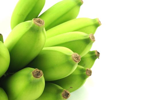 A raw banana, have large size, green colour, delicious, and beneficial to the body, on white background