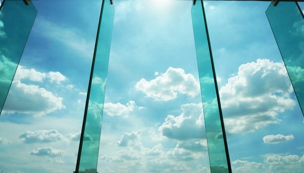 Glass window with reflection of clouds,  outside modern offifce building.                     