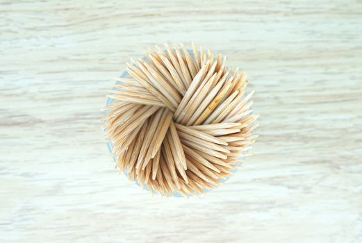 Small toothpicks made from wooden, inserted into plastic box, spheres shape.                              