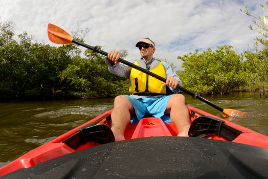 man in red kayak in florida