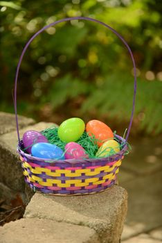 spring or easter basket with colorful eggs