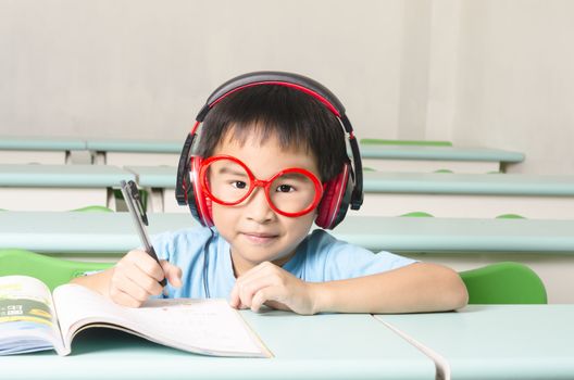 Smart student writing and wearing headphone