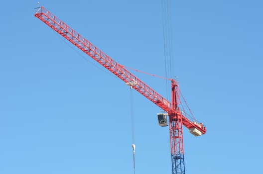 Large red and blue crane with blue sky