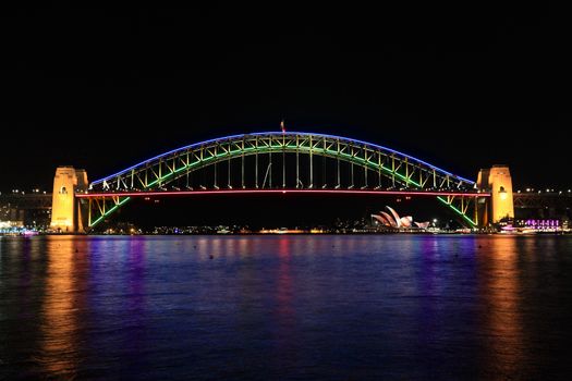 SYDNEY, AUSTRALIA - JUNE 2, 2014; The Sydney Harbour Bridge glows in a spectrum of beautiful colours during Vivid Annual Festival event
