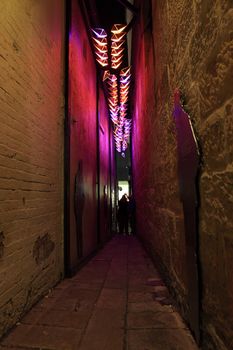 SYDNEY, AUSTRALIA - JUNE 6, 2014;  Clapiconia light installation in a narrow alleyway in The Rocks precinct during Vivid Sydney annual festival event.  The lights react and change colour to participants clapping sounds 