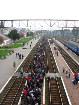 View to the people waiting for the electric train in the railway station