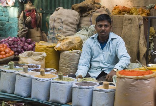 Men selling spices from a pavement stall in Delhi, India.
