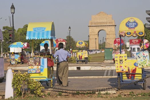 Colorful carts sell drinks and ice creams clustered around India Gate in New Delhi, India.