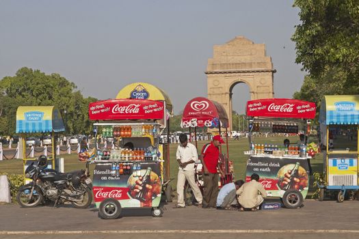 Colorful carts sell drinks and ice creams clustered around India Gate in New Delhi, India.