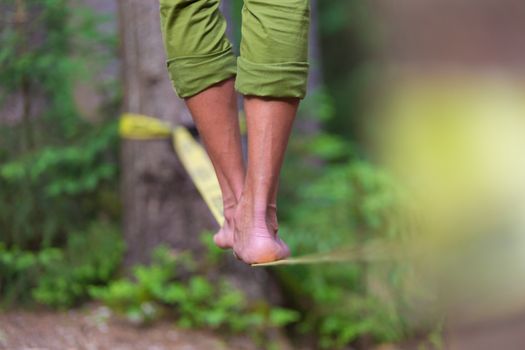 Slacklining is a practice in balance that typically uses nylon or polyester webbing tensioned between two anchor points.