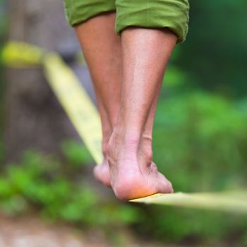 Slacklining is a practice in balance that typically uses nylon or polyester webbing tensioned between two anchor points.