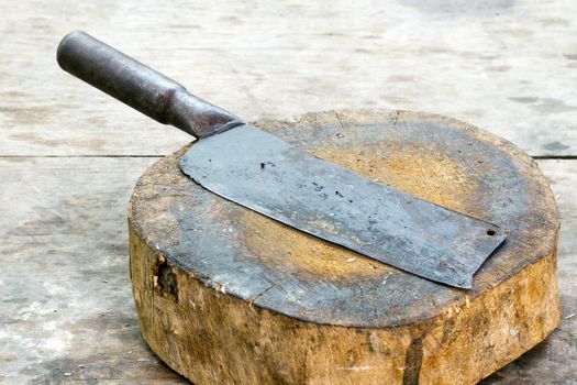 large old chef's knife on chopping block