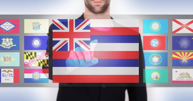 Hand pushing on a touch screen interface, choosing a state, Hawaii