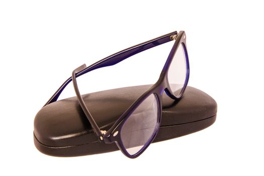 Close-up of eyeglasses with case on a white background