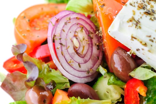 closeup of greek salad with large piece of feta