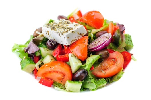 closeup of greek salad with large piece of feta