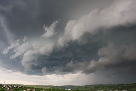 Beginning of the  storm with small tornado above the village