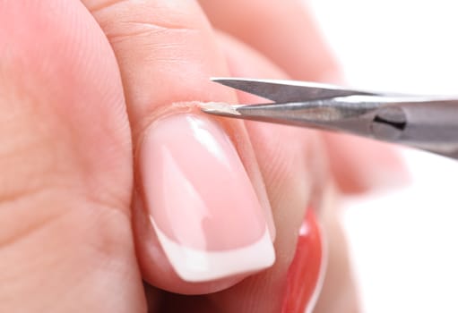 beauty salon, manicure applying, cutting the cuticle with scissors