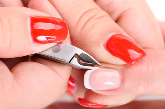 beauty salon, manicure applying, cutting the cuticle with cutter