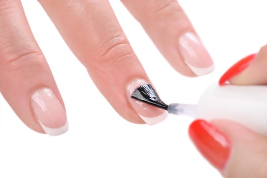 manicure applying, brushing fingernails with clear enamel