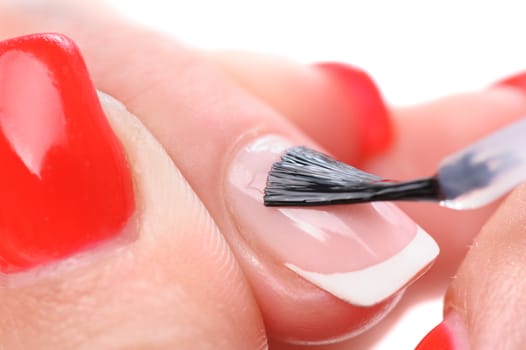 manicure applying, brushing fingernails with clear enamel