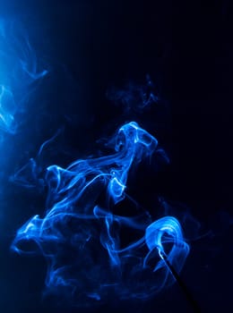 Flowing blue smoke on a black background. Isolated