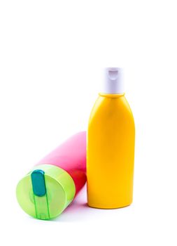 the colorful lotion bottles on the white background ideal for health care product purposes