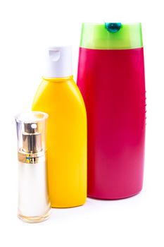 the colorful lotion bottles on the white background ideal for health care product purposes