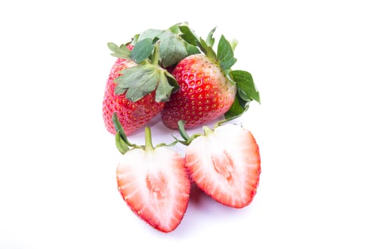 beautiful fresh strawberry with green leaves on the white background