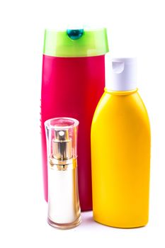 the colorful lotion bottles on the white background ideal for health care product purposes