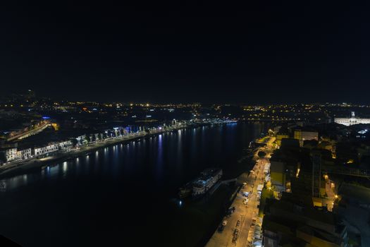 City at night, panoramic scene of downtown reflected in water