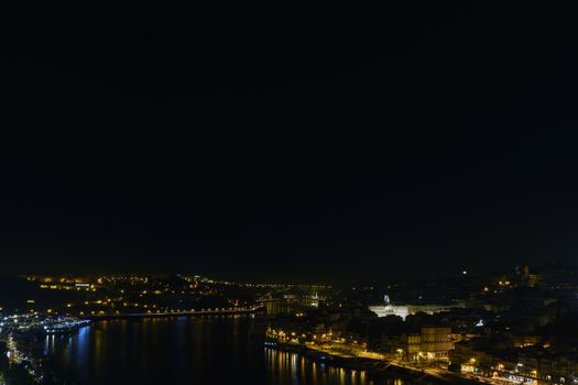 City at night, panoramic scene of downtown reflected in water