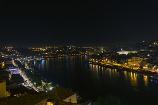 City at night, panoramic scene of downtown reflected in water