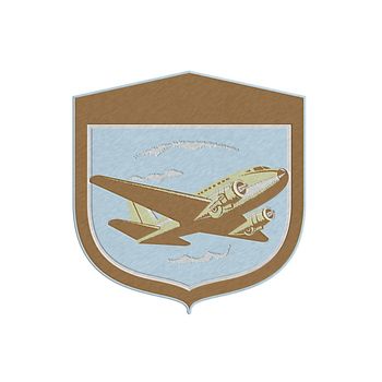 Metallic styled illustration of a DC10 propeller airplane airliner on flight flying set inside shield crest shape on isolated background done in retro style.