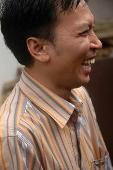 cikijing, west java, indonesia - july 10, 2011: expression of man laughing