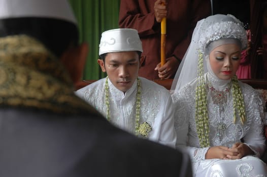 cikijing, west java, indonesia - july 10, 2011: bride and groom wearing traditional west java wedding costume