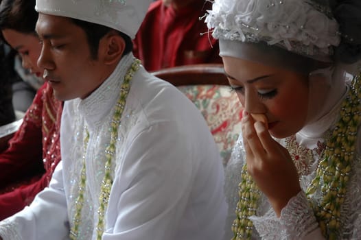 cikijing, west java, indonesia - july 10, 2011: bride and groom wearing traditional west java wedding costume