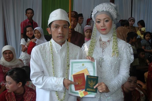 cikijing, west java, indonesia - july 10, 2011: bride and groom wearing traditional west java wedding costume