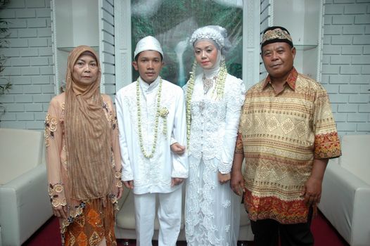 cikijing, west java, indonesia - july 10, 2011: bride and groom wearing traditional west java wedding costume