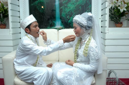 cikijing, west java, indonesia - july 10, 2011: bride and groom wearing traditional west java wedding costume