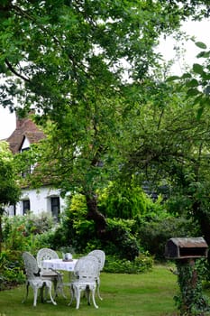 White iron table and chairs in english garden