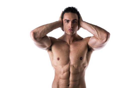 Muscular shirtless young man covering ears with hands, isolated on white