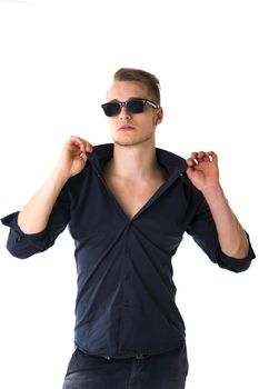Cool confident blond young man with sunglasses and blue shirt, isolated on white
