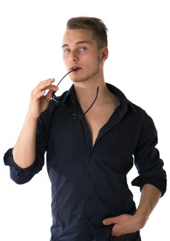 Cool confident blond young man with sunglasses and blue shirt, isolated on white