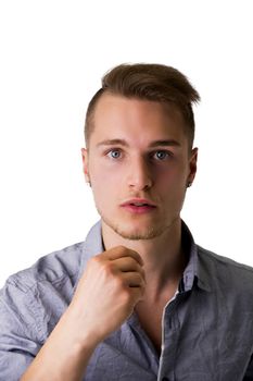 Handsome young man with aggressive, challenging expression, isolated on white