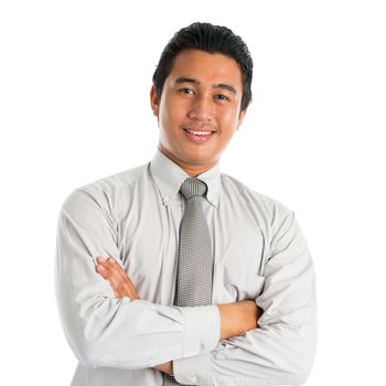 Portrait of handsome Asian young man in casual business attire, smiling confidently with arms crossed, standing isolated on white background.